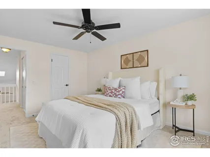 a bedroom with a bed and a painting on the wall