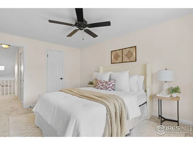 a bedroom with a bed and a painting on the wall