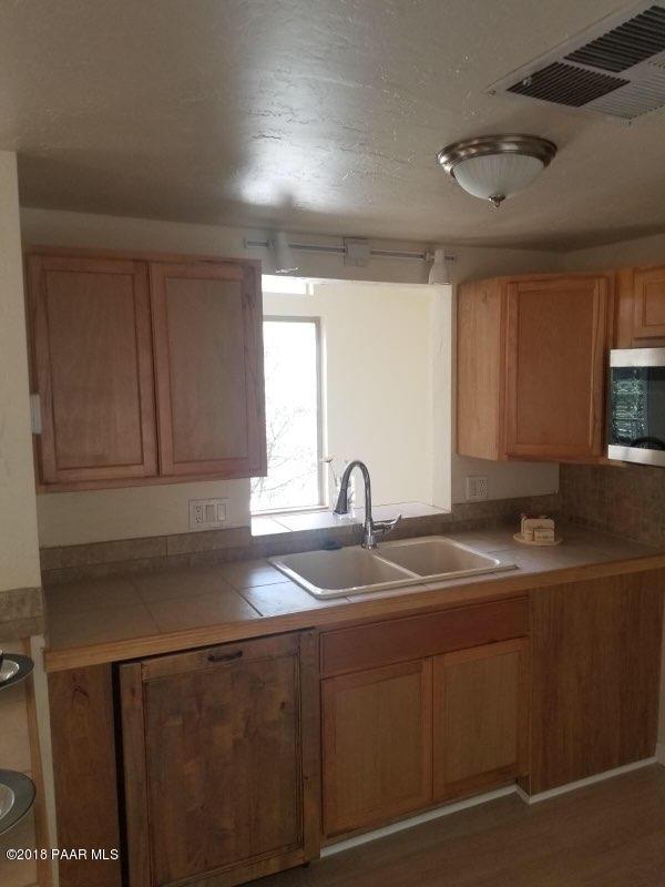 1520 White Spar Road Prescott, AZ 86303 - Photo 9 of 20 a kitchen with kitchen island granite countertop a sink stainless steel appliances and cabinets