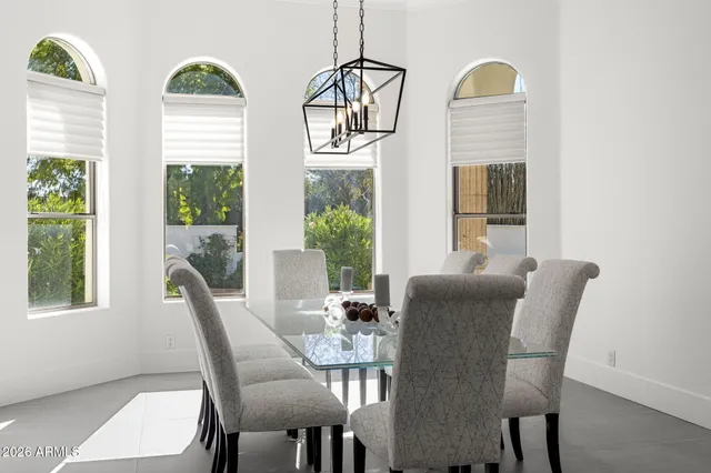 a view of a dining room with furniture wooden floor and windows