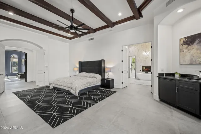 a living room with furniture a chandelier and a rug