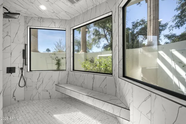 a view of a large room with a large window and wooden floor