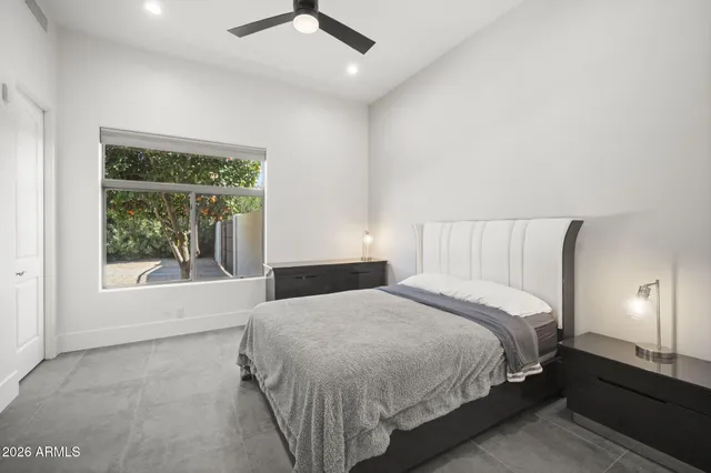 a bedroom with a large bed and a large window