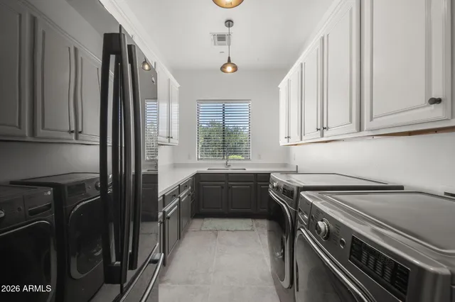 a kitchen that has a sink a stove and cabinets
