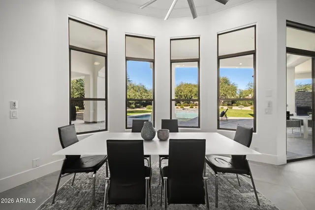 a view of a dining room with furniture large windows and wooden floor