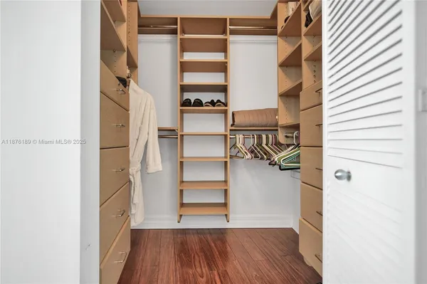 a view of walk in closet with empty racks