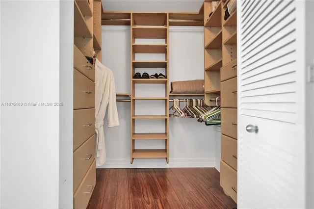 a view of walk in closet with empty racks
