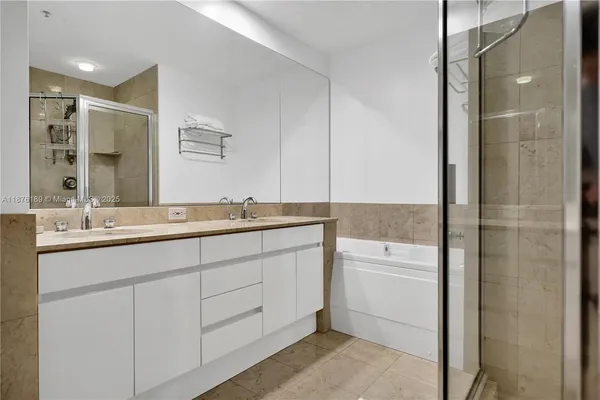 a bathroom with a double vanity sink and mirror