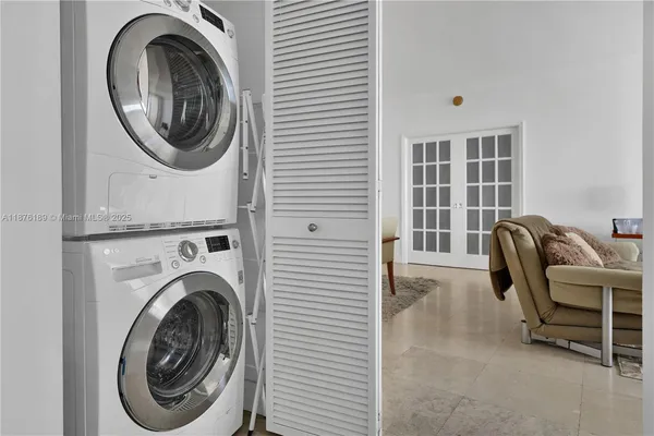 a view of a bedroom with washer and dryer