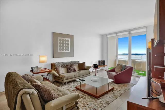 a living room with furniture or couch and a large window