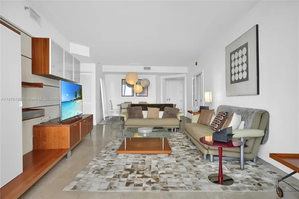 a living room with furniture and a rug