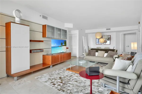 a living room with furniture and a rug