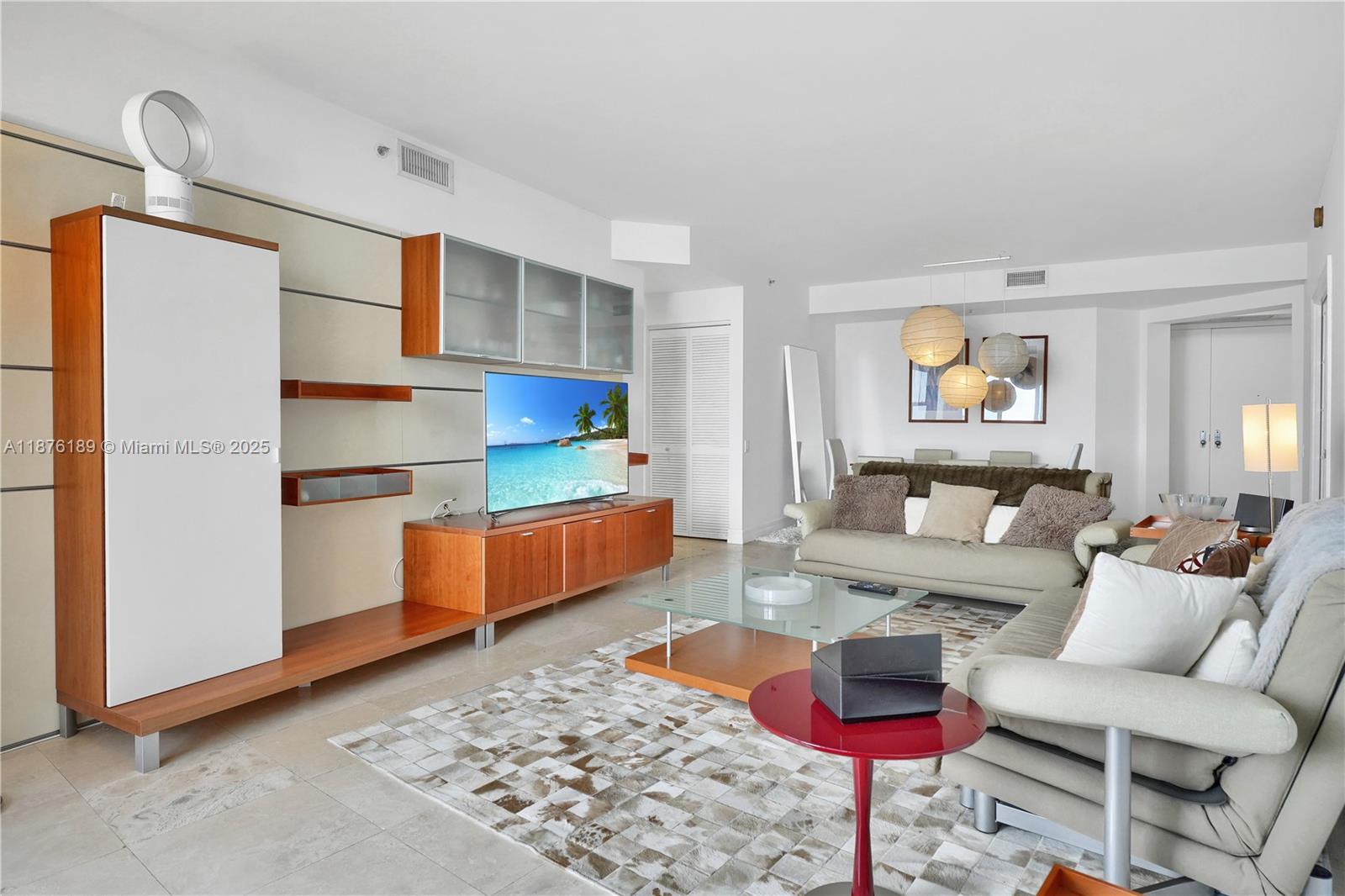 808 Brickell Key Drive, Unit 2506 Miami, FL 33131 - Photo 6 of 30 a living room with furniture and a rug