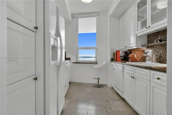 a kitchen with stainless steel appliances a refrigerator and cabinets
