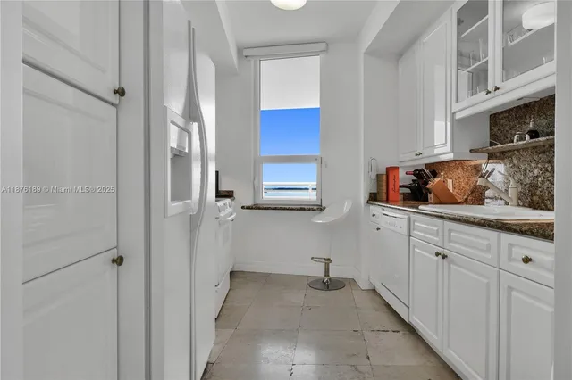 a kitchen with stainless steel appliances a refrigerator and cabinets