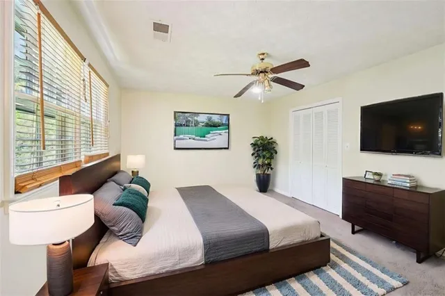 a bedroom with a bed and a flat screen tv