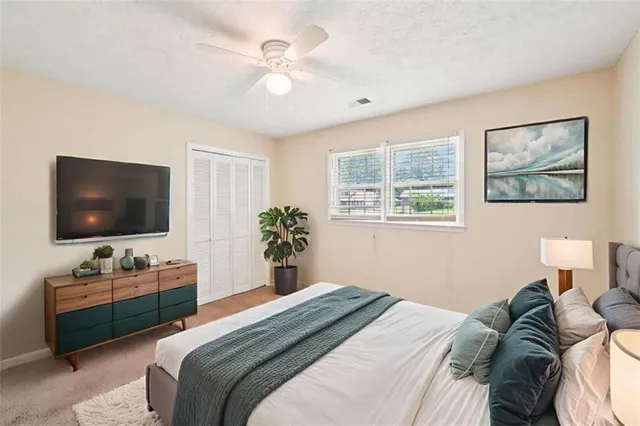 a bedroom with a bed and a flat screen tv