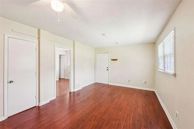 wooden floor in an empty room with a window