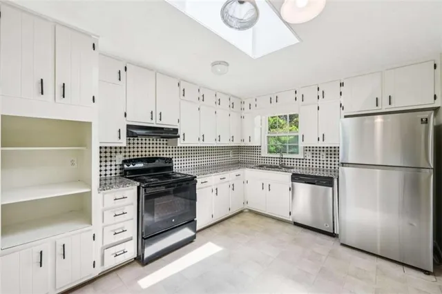 a kitchen with white cabinets and white appliances