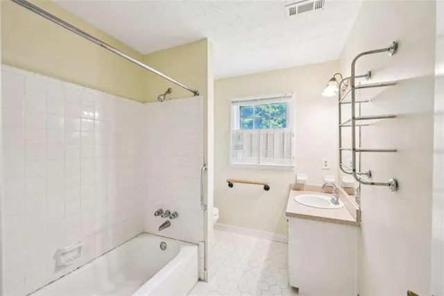 a bathroom with a tub sink and mirror
