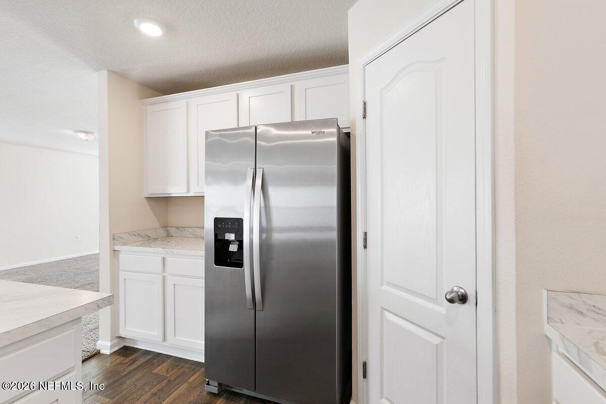 233 Falcon Ridge Road St. Augustine, FL 32084 - Photo 11 of 34 a metallic refrigerator freezer sitting in a kitchen