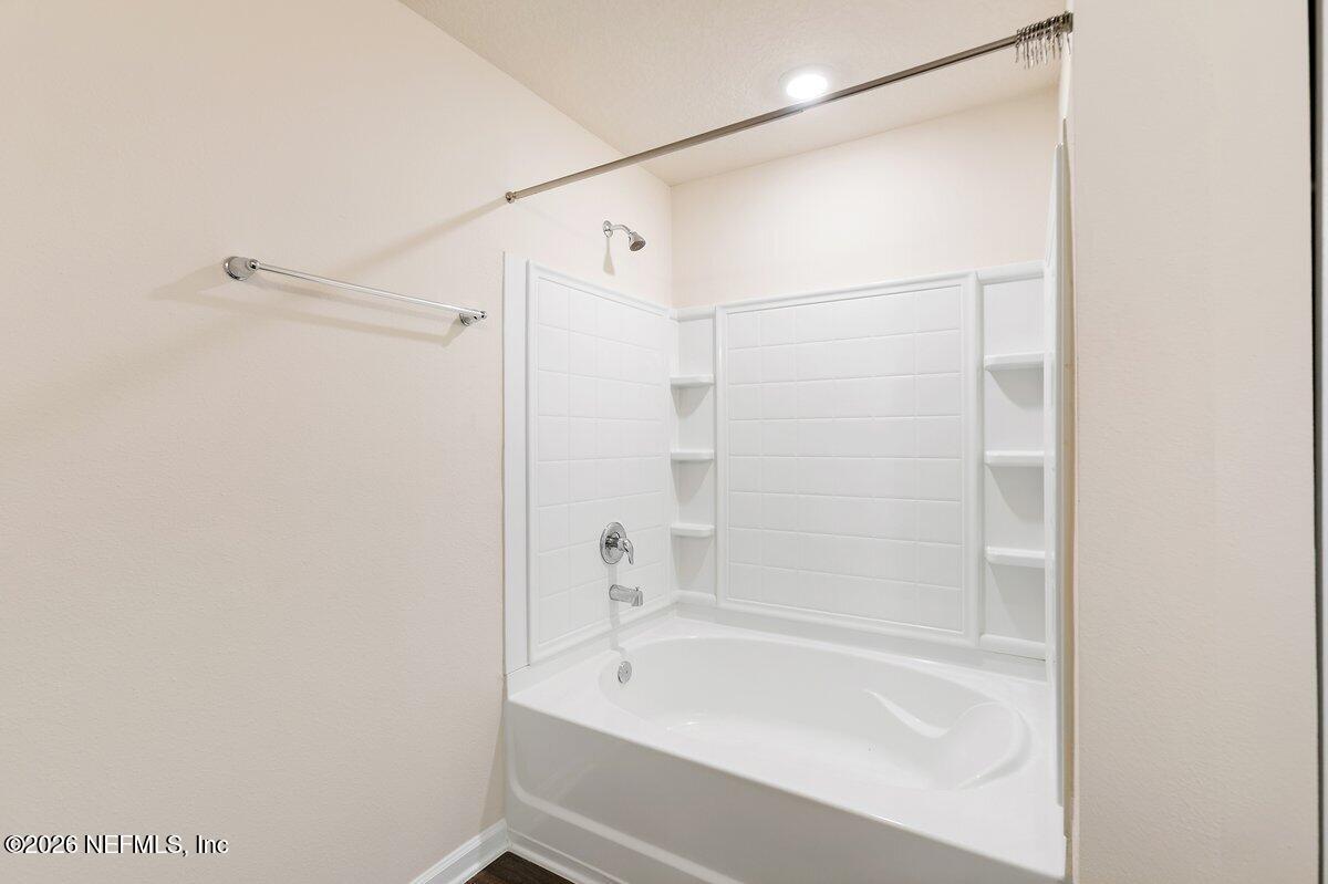 233 Falcon Ridge Road St. Augustine, FL 32084 - Photo 15 of 34 a bathroom with a bathtub and a shower