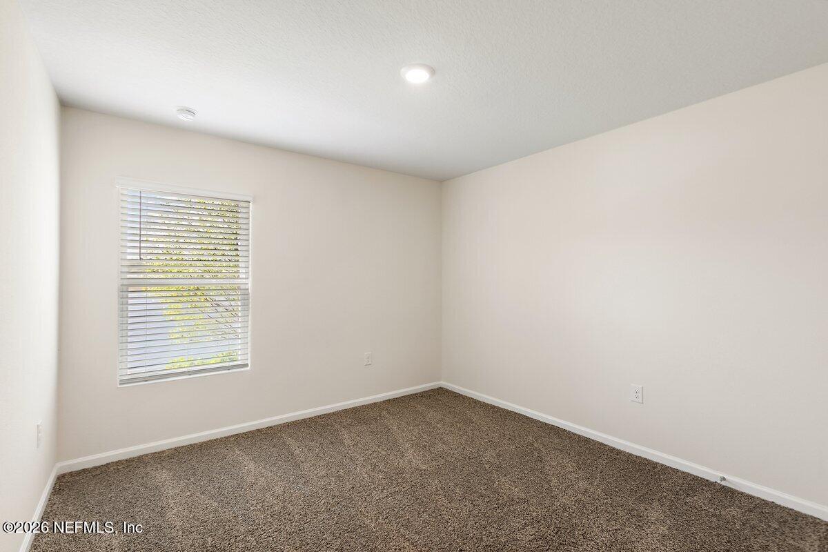 233 Falcon Ridge Road St. Augustine, FL 32084 - Photo 17 of 34 an empty room with a window
