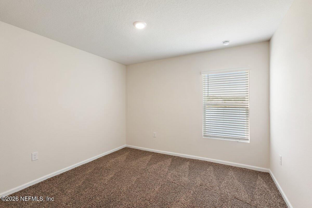 233 Falcon Ridge Road St. Augustine, FL 32084 - Photo 18 of 34 an empty room with a window