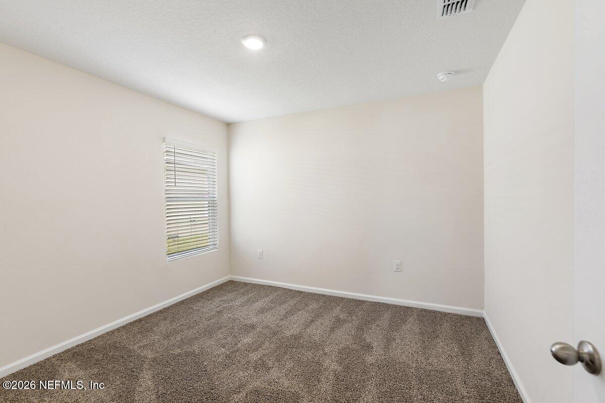 233 Falcon Ridge Road St. Augustine, FL 32084 - Photo 19 of 34 a view of an empty room with a window