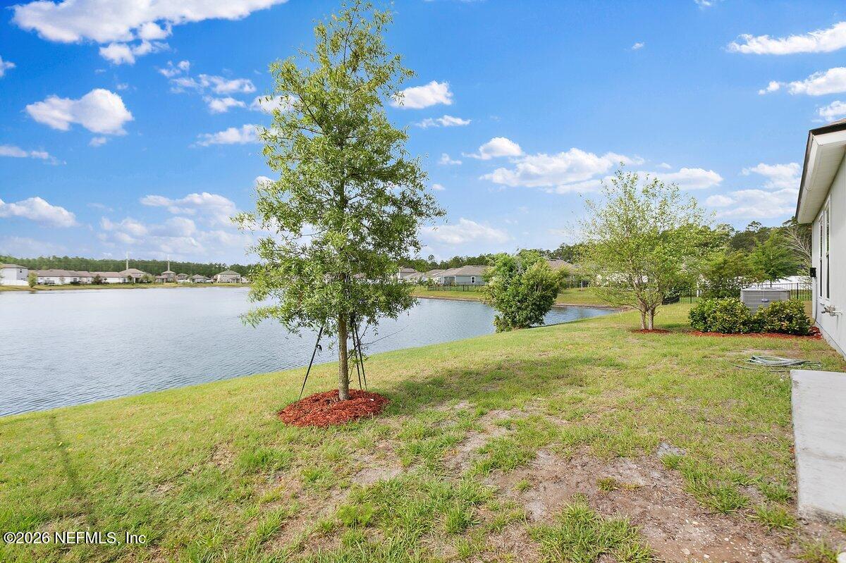 233 Falcon Ridge Road St. Augustine, FL 32084 - Photo 22 of 34 a view of a lake with a yard