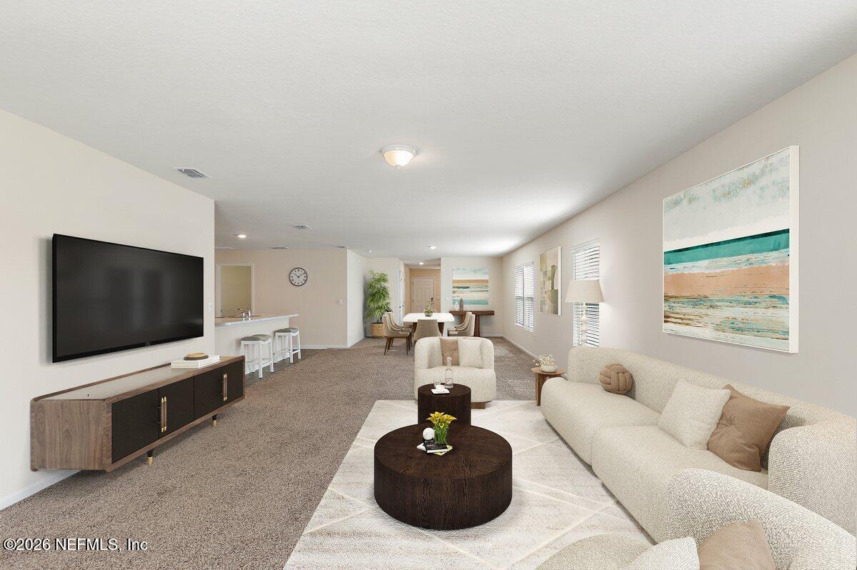 233 Falcon Ridge Road St. Augustine, FL 32084 - Photo 6 of 34 a living room with furniture and a flat screen tv