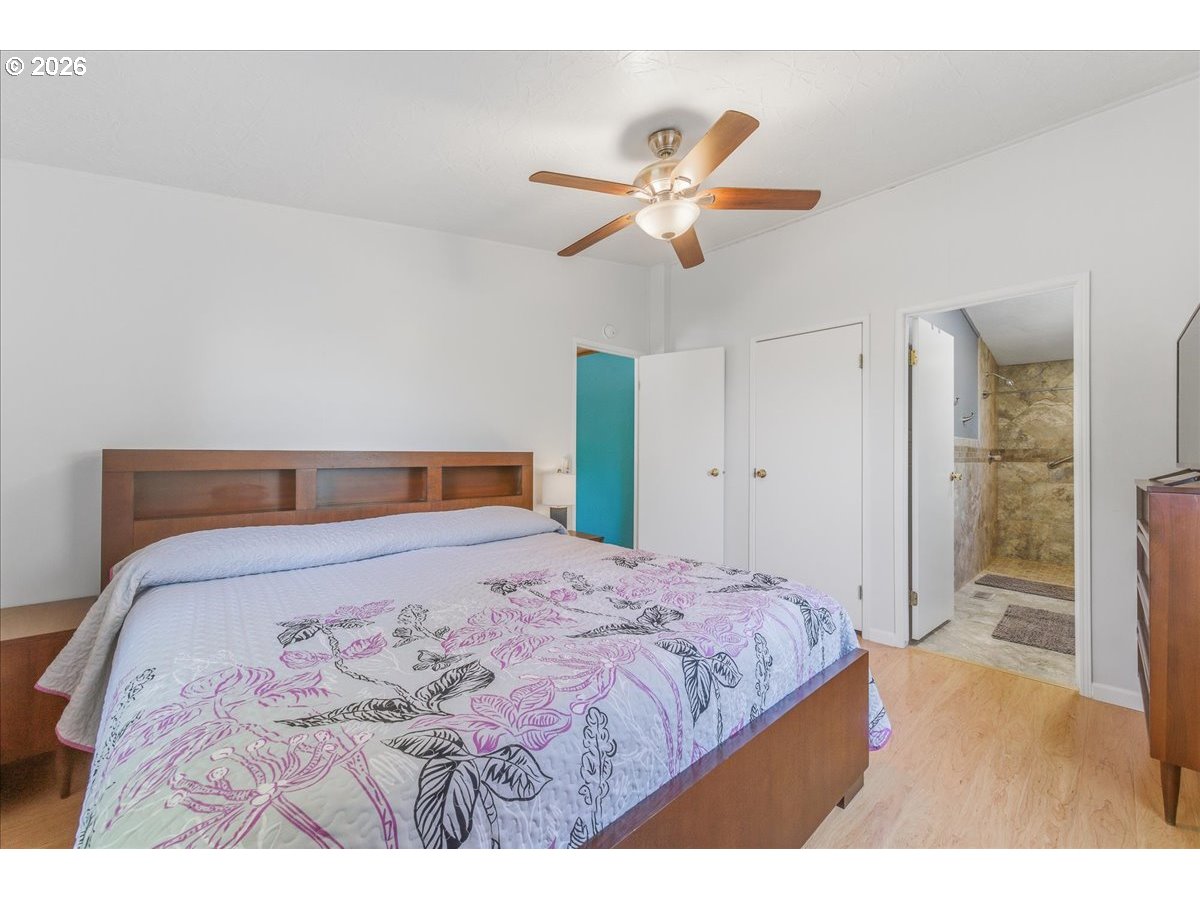 475 East 9th Street Rainier, OR 97048 - Photo 14 of 43 a bedroom with a bed and a chandelier