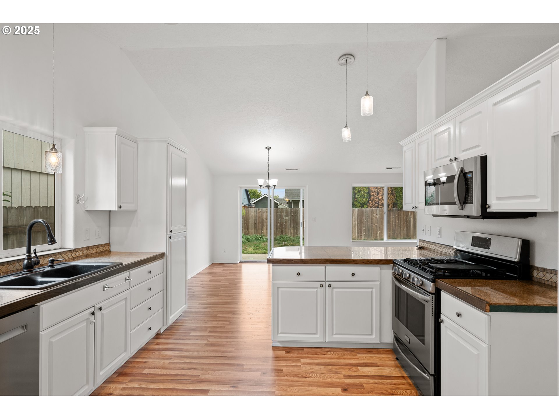 1237 South 7th Street Independence, OR 97351 - Photo 13 of 29 a large kitchen with stainless steel appliances kitchen island granite countertop a sink and cabinets