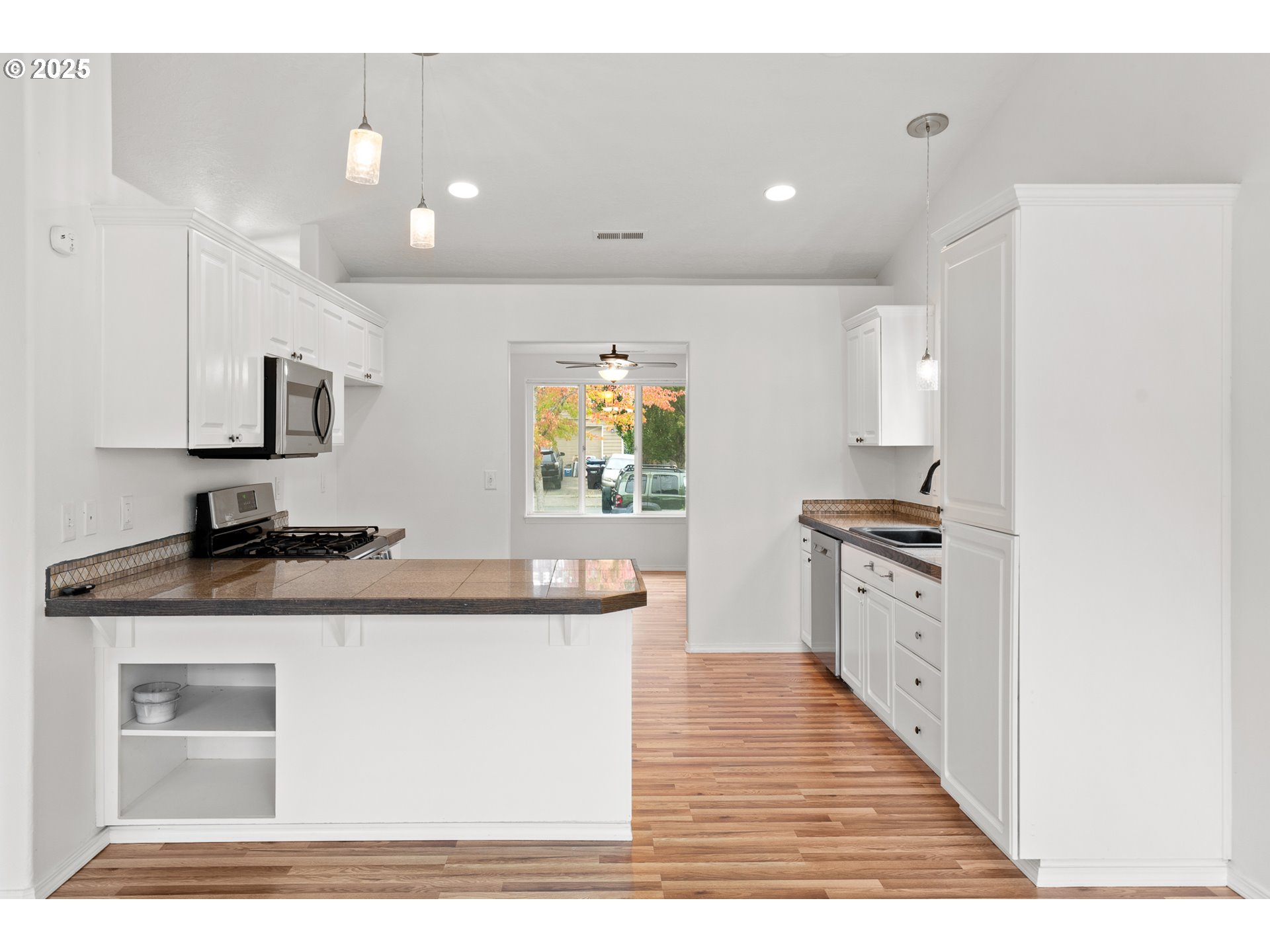 1237 South 7th Street Independence, OR 97351 - Photo 10 of 29 a kitchen with stainless steel appliances granite countertop a sink stove and refrigerator