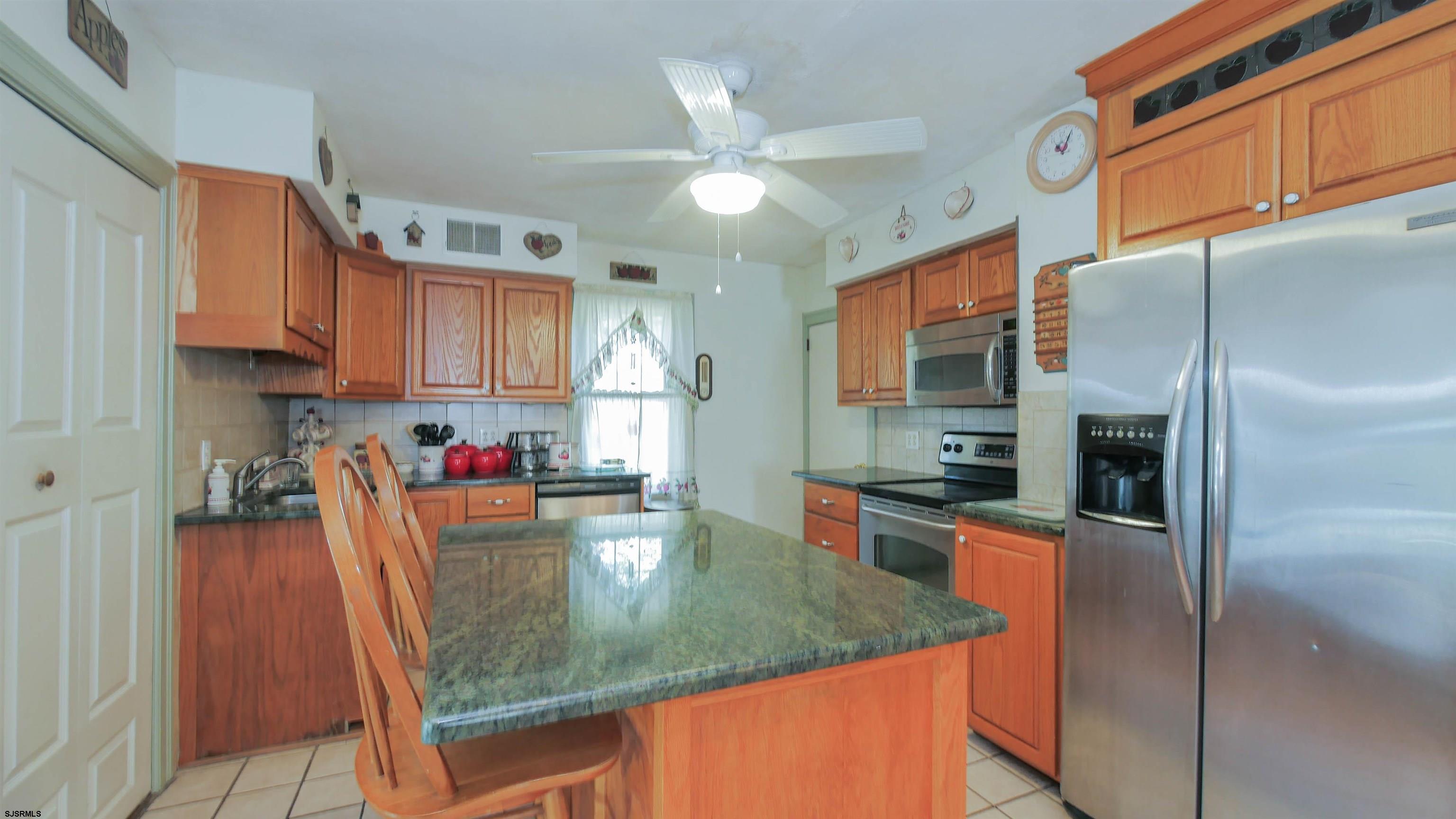 346 Tuckahoe Road Vineland, NJ 08360 - Photo 11 of 44 a kitchen with stainless steel appliances granite countertop a refrigerator a stove and a sink