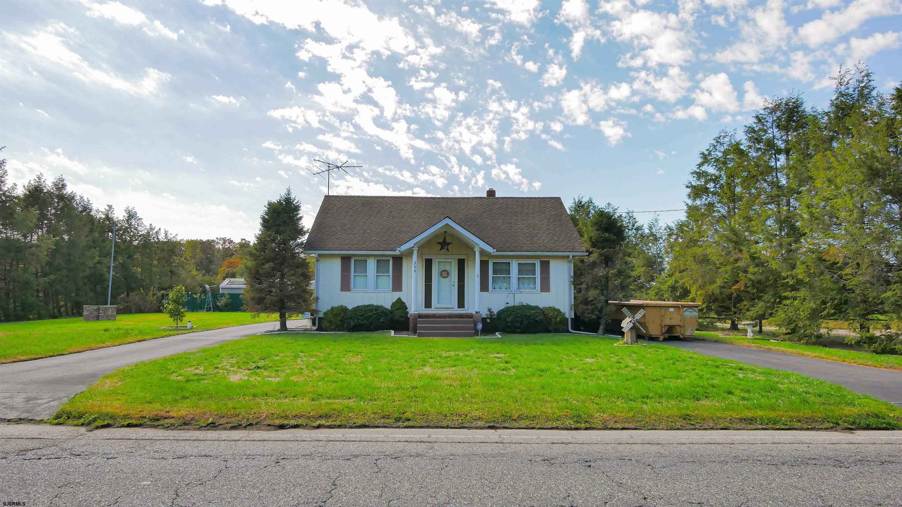 346 Tuckahoe Road Vineland, NJ 08360 - Photo 2 of 44 a view of a house next to a big yard and large trees