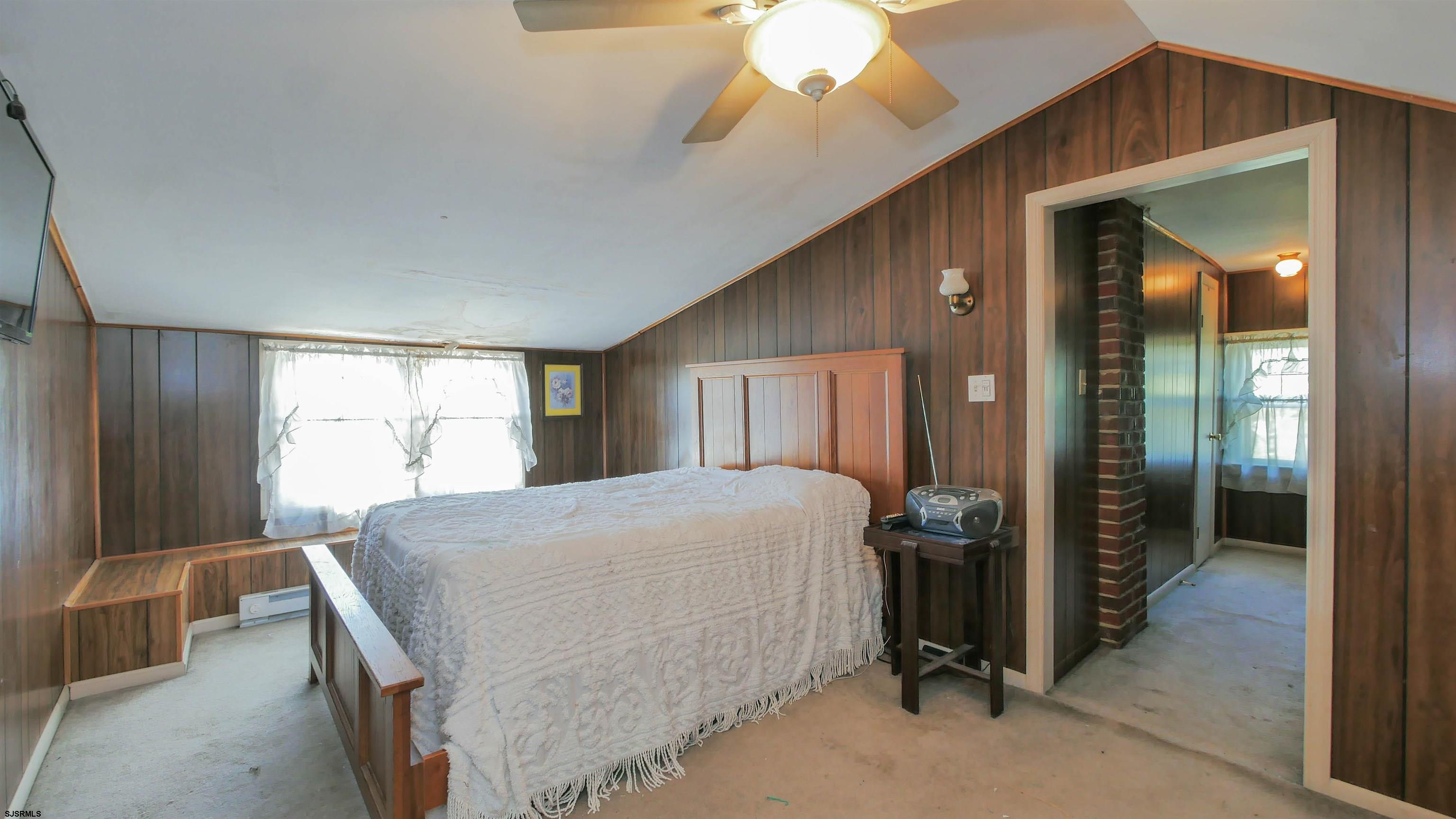 346 Tuckahoe Road Vineland, NJ 08360 - Photo 22 of 44 a bedroom with a bed and a chandelier