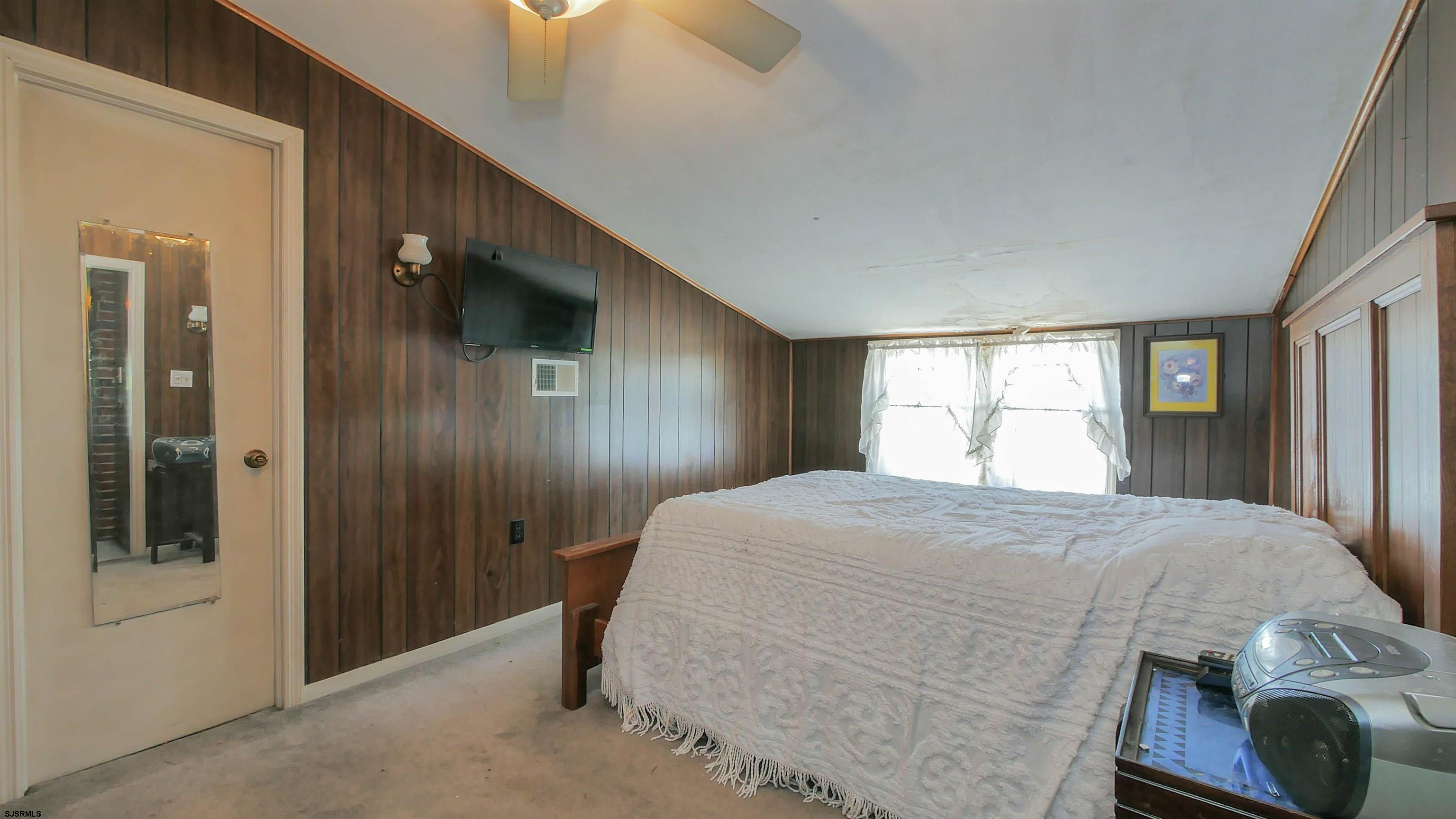 346 Tuckahoe Road Vineland, NJ 08360 - Photo 23 of 44 a bedroom with a large bed and a window