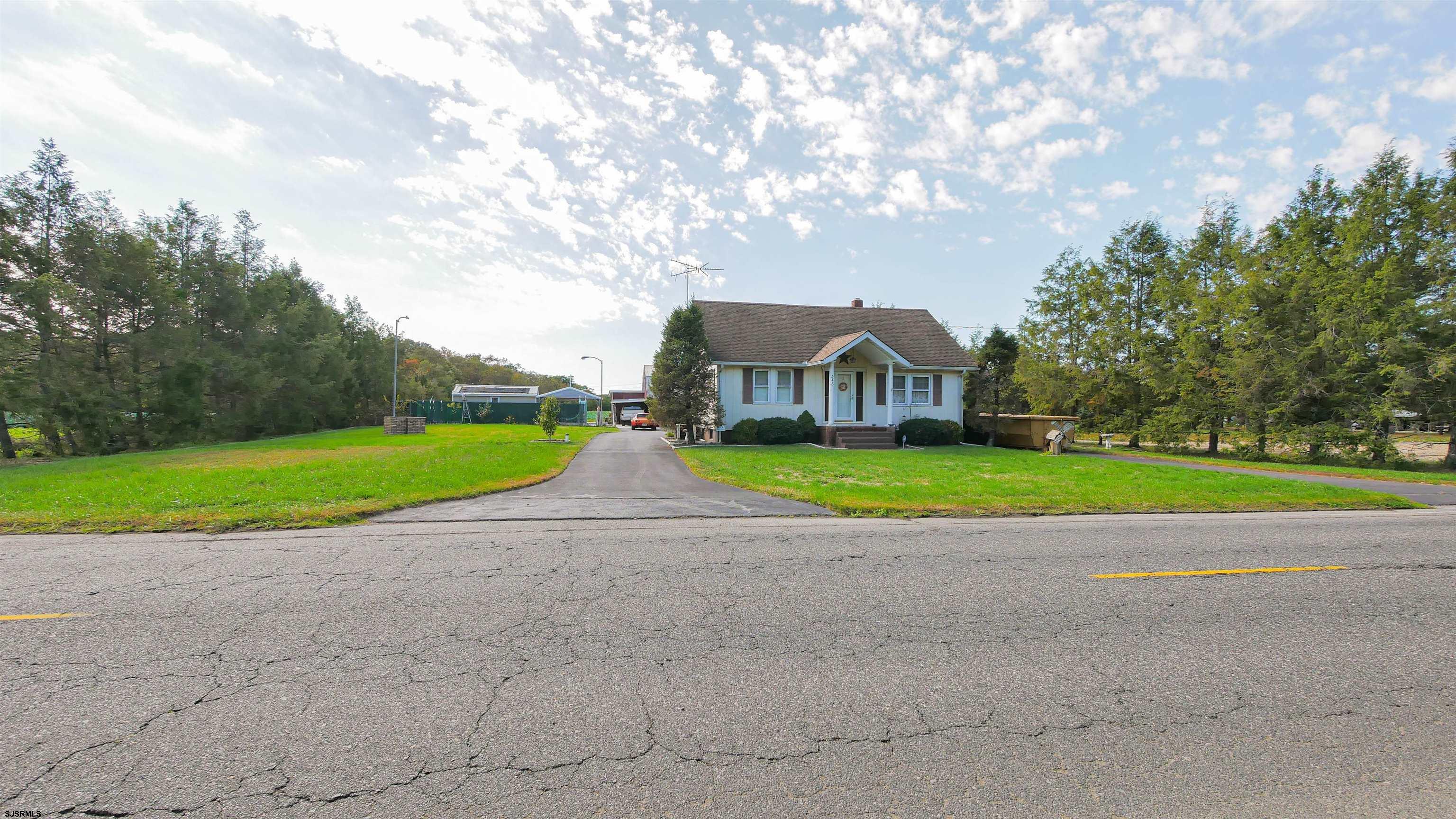 346 Tuckahoe Road Vineland, NJ 08360 - Photo 3 of 44 a view of a house with a big yard and large trees