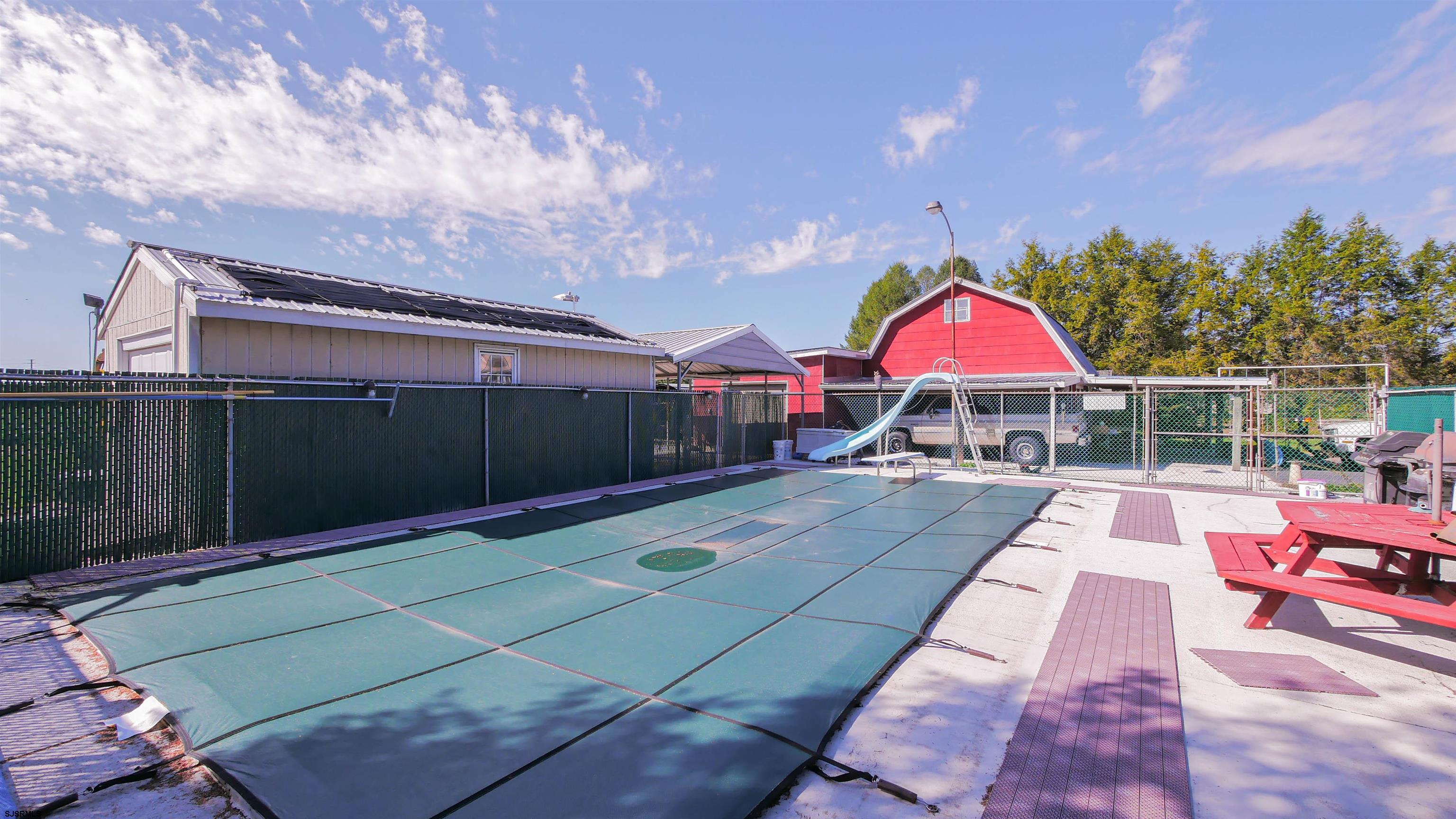 346 Tuckahoe Road Vineland, NJ 08360 - Photo 32 of 44 a view of yard with swimming pool and table and chairs