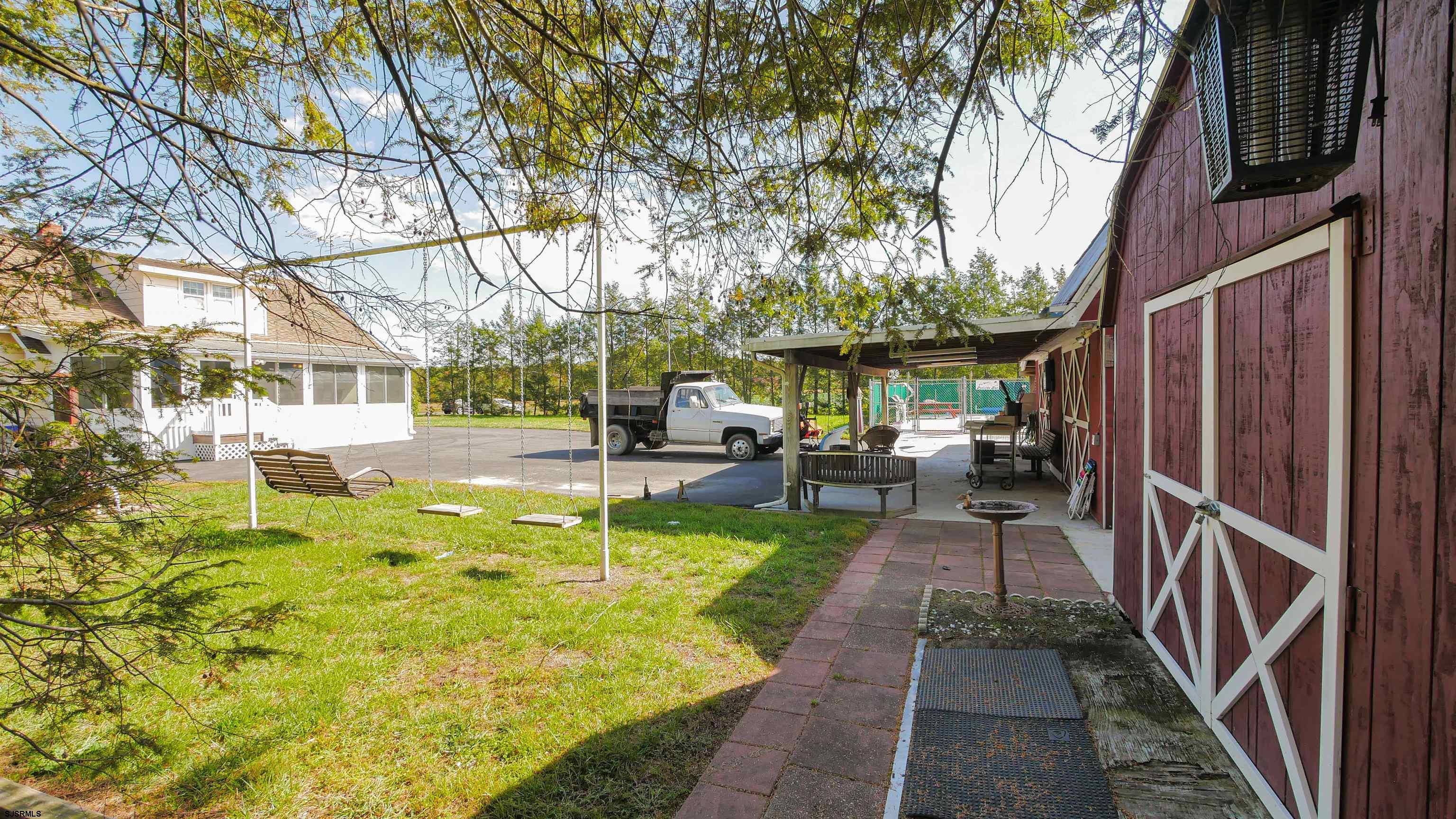346 Tuckahoe Road Vineland, NJ 08360 - Photo 8 of 44 a view of a patio with couches plants and large tree