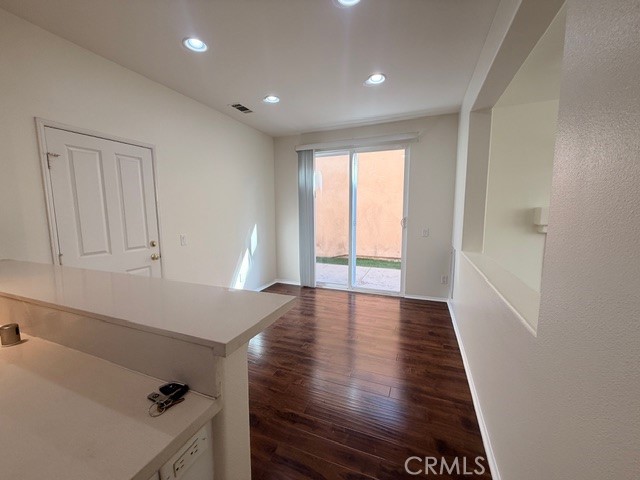 5 Del Mar Irvine, CA 92602 - Photo 5 of 15 a view of an empty room with wooden floor and a window