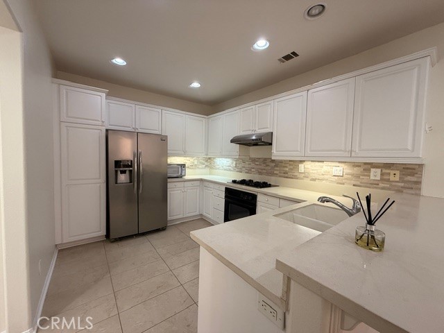 5 Del Mar Irvine, CA 92602 - Photo 6 of 15 a kitchen with stainless steel appliances granite countertop a refrigerator sink and cabinets