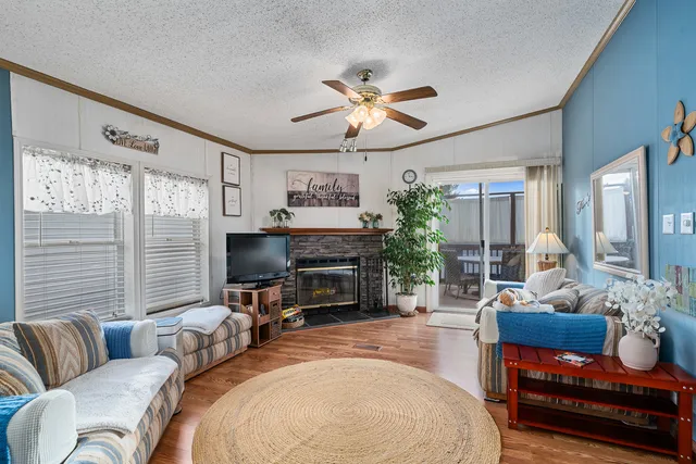 a living room with furniture a fireplace and a flat screen tv