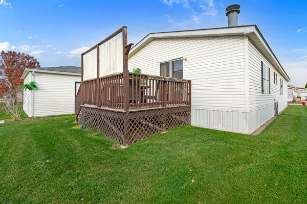a view of backyard with deck and garden