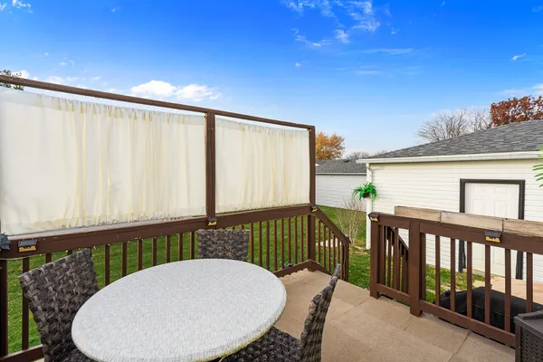 a view of a chairs and table in the balcony