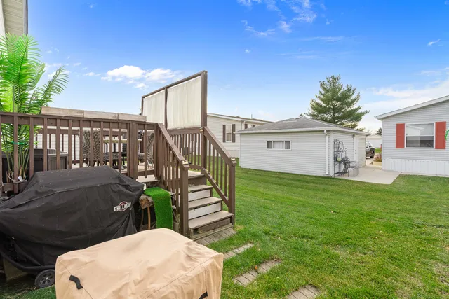 a view of a patio with table and chairs with wooden fence and plants