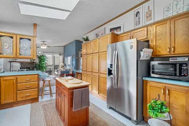 a kitchen with stainless steel appliances granite countertop a refrigerator a oven and a stove