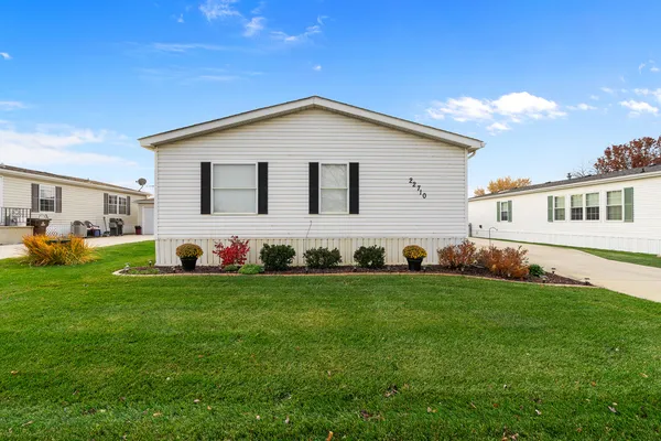 a view of a backyard with plants and a garden