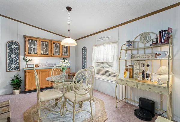 a view of a dining room with furniture window and outside view